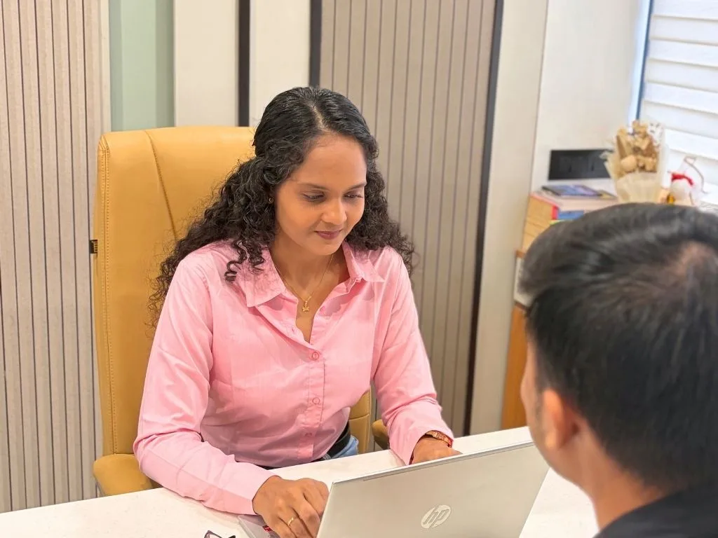 Riddhi in consultation with a client at the clinic