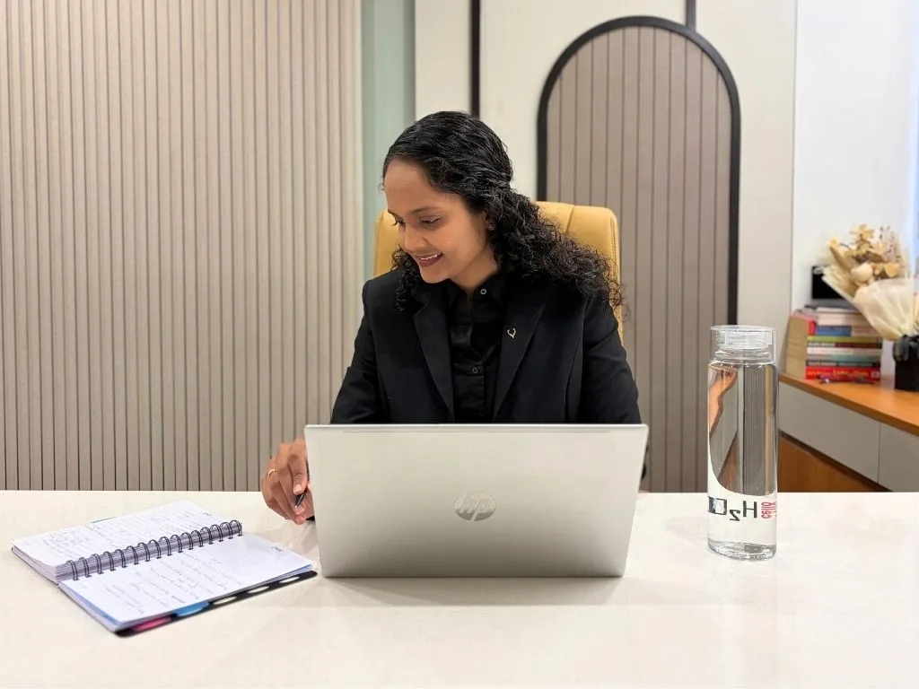 Riddhi working through a client plan at her desk