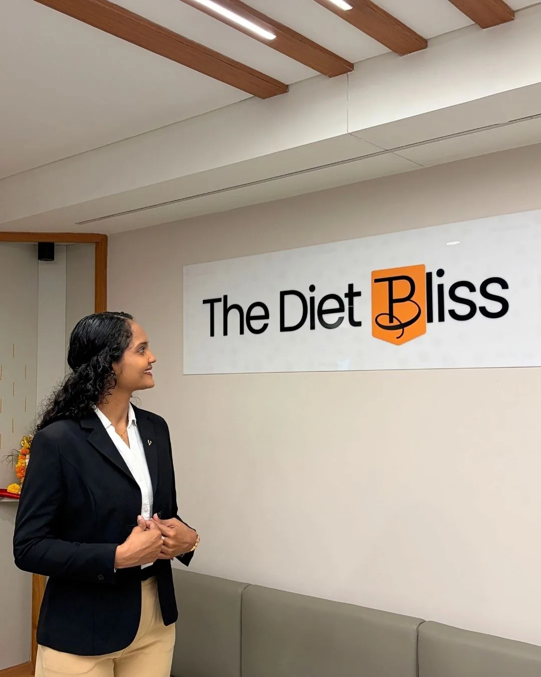 Riddhi beside The Diet Bliss signage at the clinic